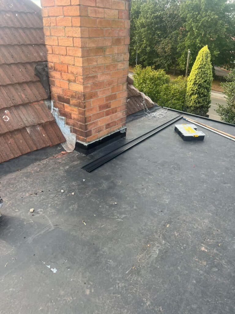 This is a photo of a flat roof which has just been repaired, there is also a chimney stack and some leadwork has also been dressed. Works carried out by Kidderminster Roofing Repairs